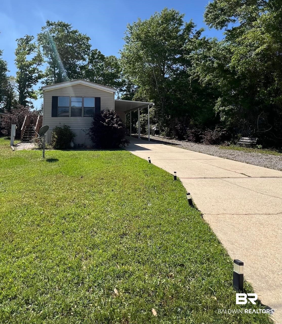 1936 Ridgewood Drive Lillian, AL 36549 - Photo 1 of 30 View of front of property with a carport, driveway, and a front yard