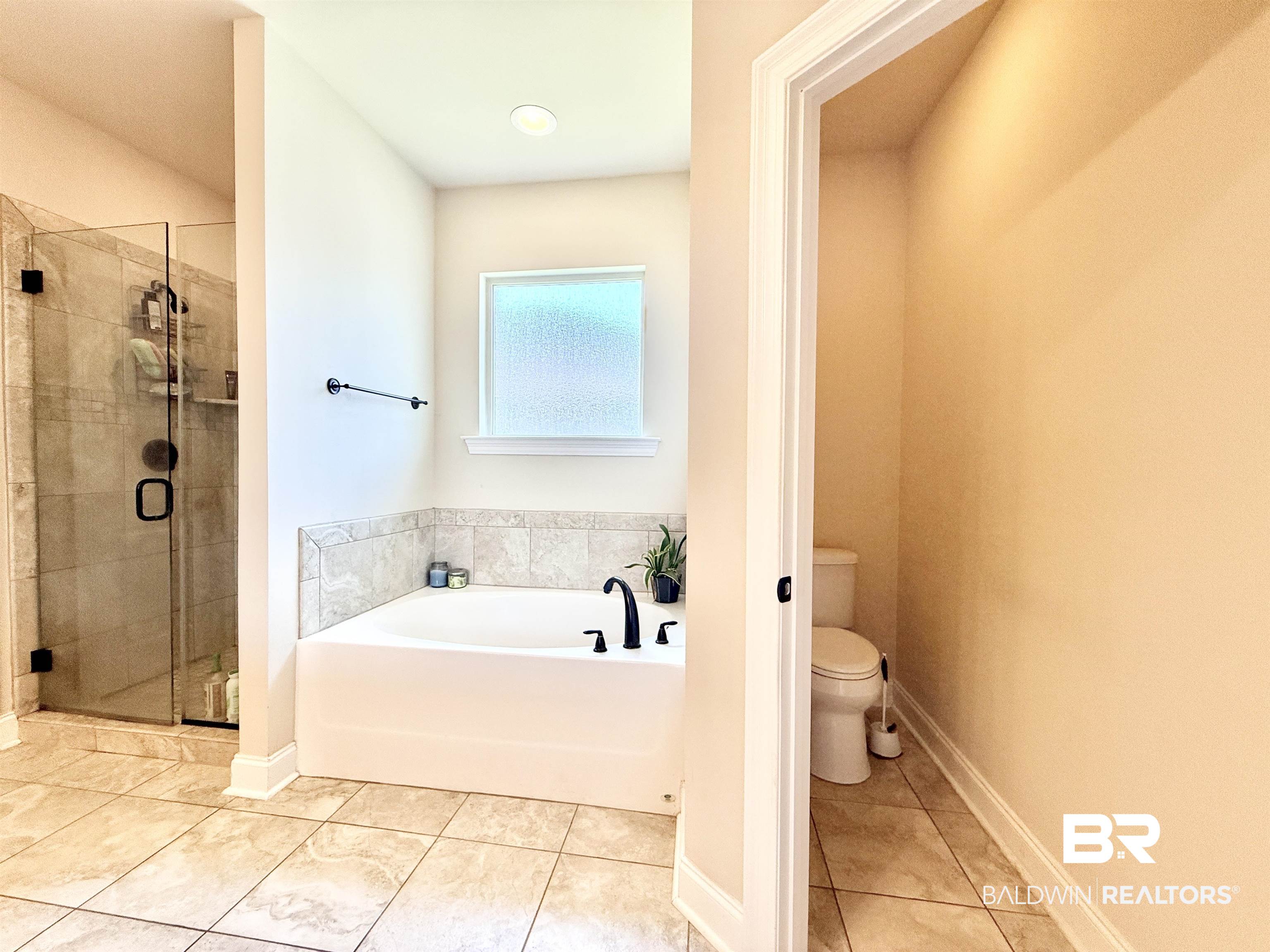 7011 Rocky Rd Loop Gulf Shores, AL 36542 - Photo 30 of 66 Full bathroom with a garden tub, a stall shower, and tile patterned floors
