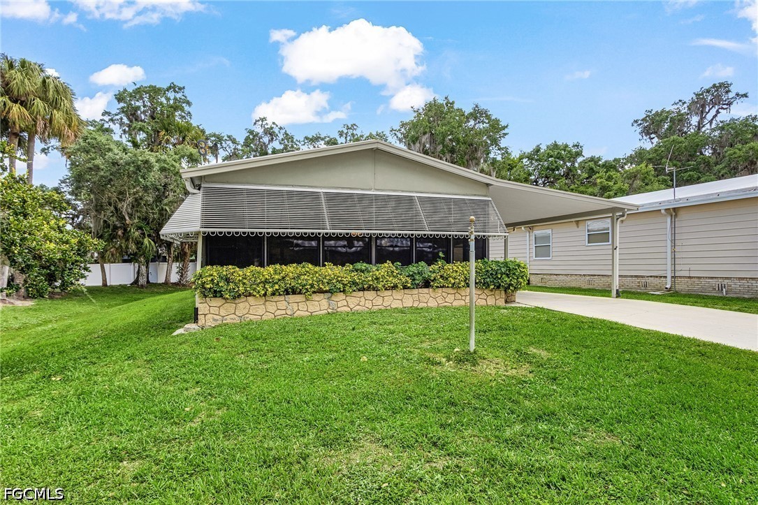 5 Erica Street Alva, FL 33920 - Photo 28 of 37 a view of a house with a backyard and a garden