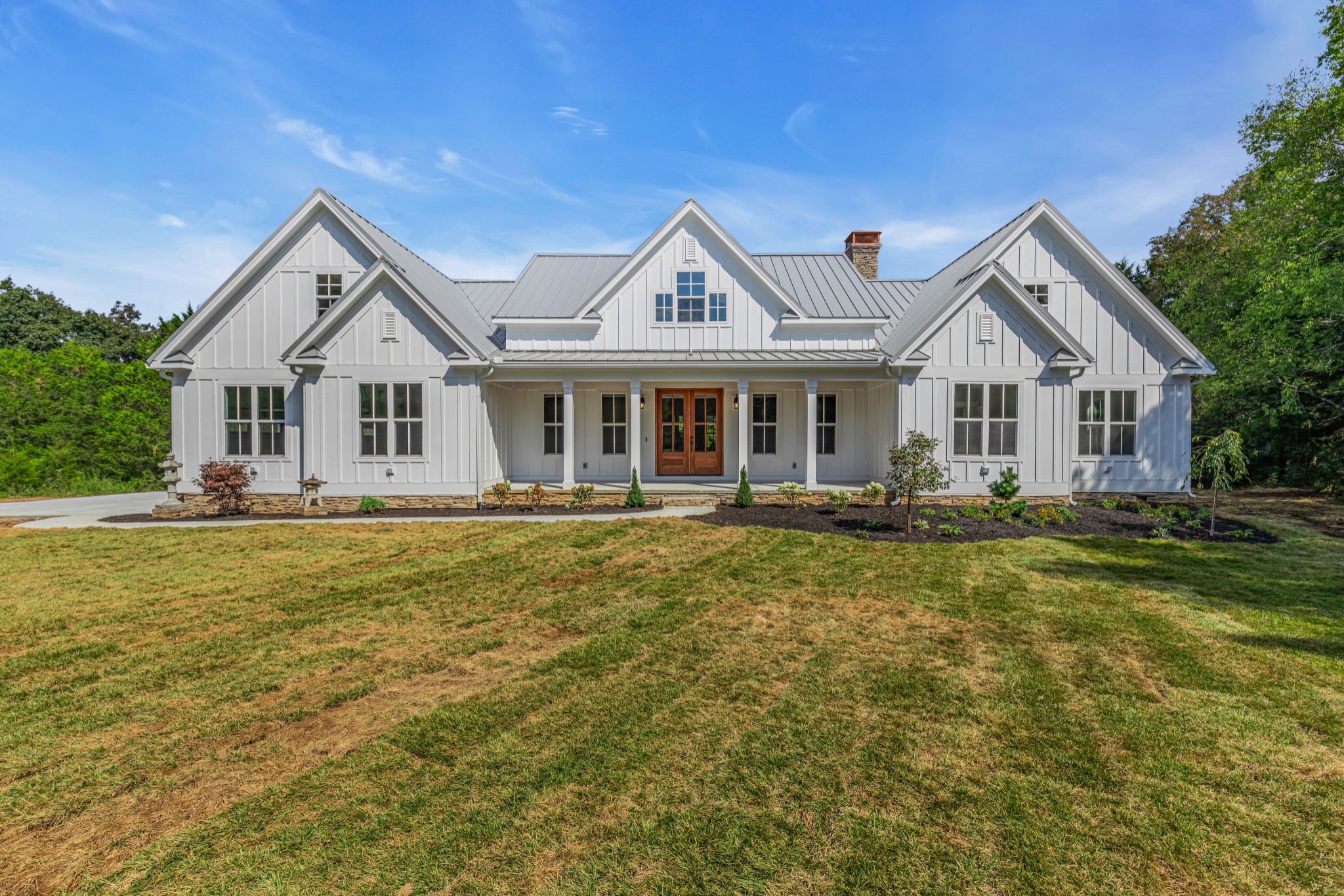 2171 Carpenter Bridge Road Columbia, TN 38401 - Photo 1 of 1 a front view of a house with a garden and lake view