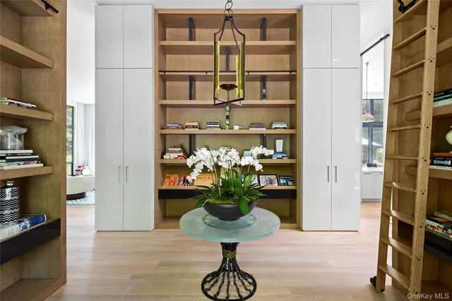 a vase of flowers sitting on a table with table and chair