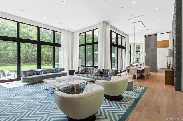 a living room with furniture and large windows