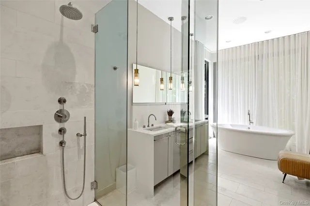 a bathroom with a granite countertop sink a mirror and a shower