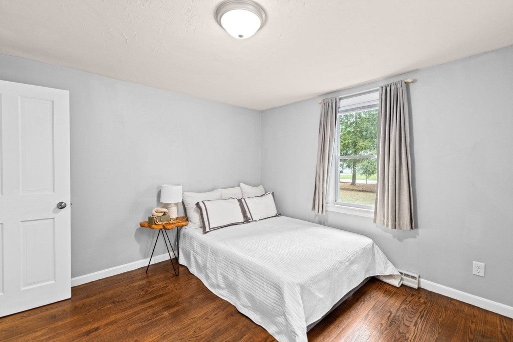 74 Rochester Road Carver, MA 02330 - Photo 14 of 31 a bedroom with a bed and wooden floor