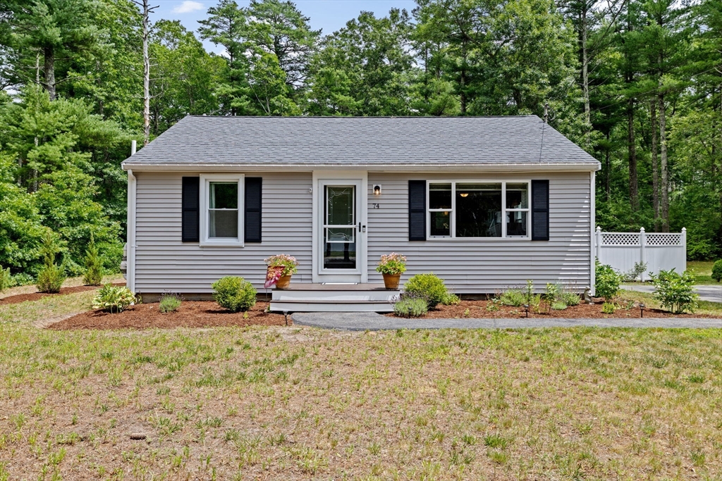 74 Rochester Road Carver, MA 02330 - Photo 2 of 31 a front view of a house with a yard