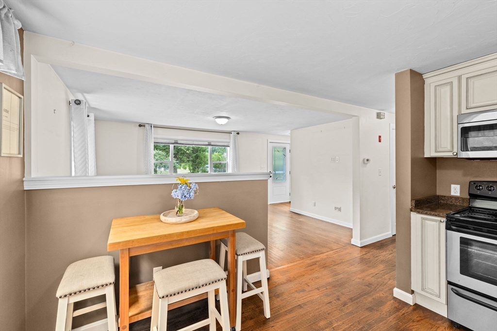 74 Rochester Road Carver, MA 02330 - Photo 6 of 31 a kitchen with granite countertop a stove a sink and a refrigerator