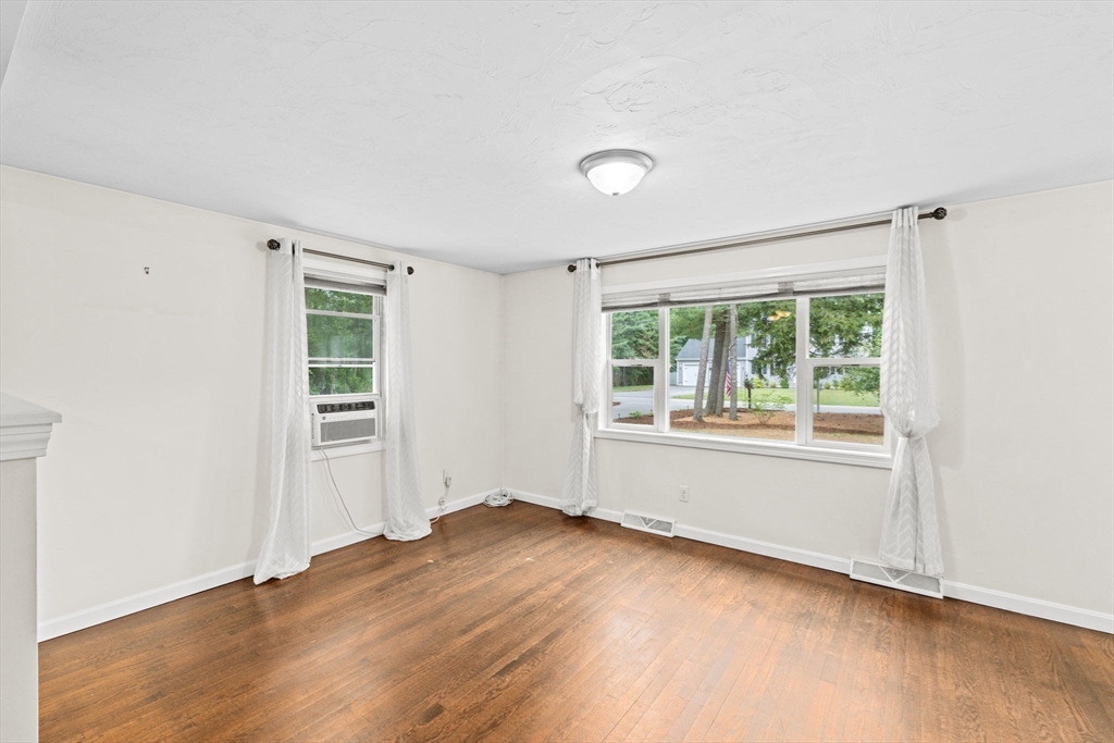 74 Rochester Road Carver, MA 02330 - Photo 8 of 31 an empty room with wooden floor and windows