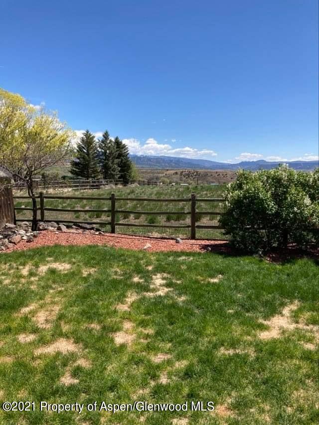 1394 Firethorn Drive Rifle, CO 81650 - Photo 11 of 43 a view of a golf course with a lake