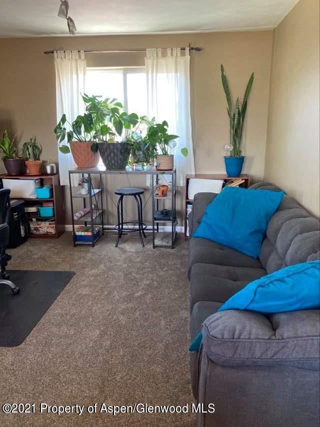 1394 Firethorn Drive Rifle, CO 81650 - Photo 13 of 43 a living room with furniture and a large window