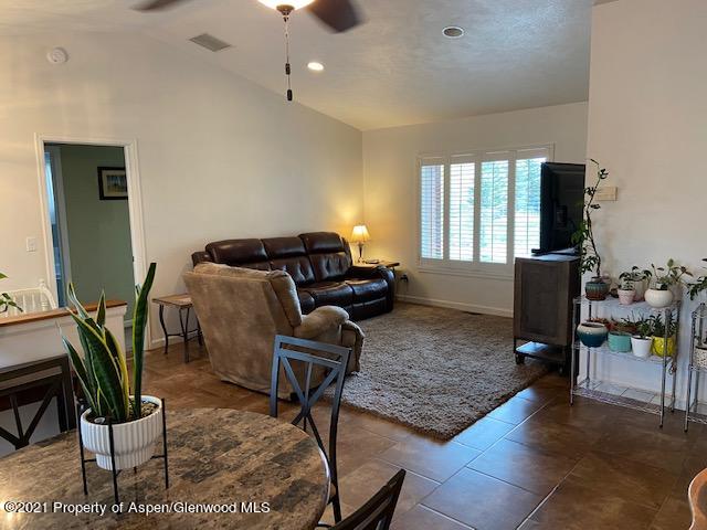 1394 Firethorn Drive Rifle, CO 81650 - Photo 16 of 43 a living room with furniture rug and window