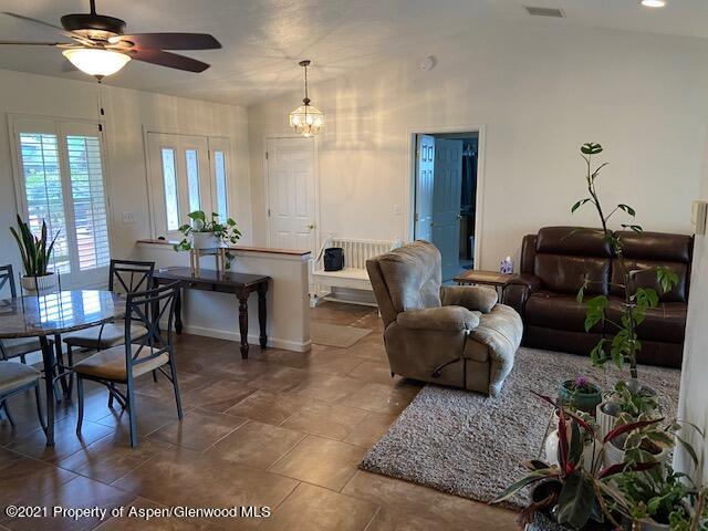 1394 Firethorn Drive Rifle, CO 81650 - Photo 17 of 43 a living room with furniture and a chandelier