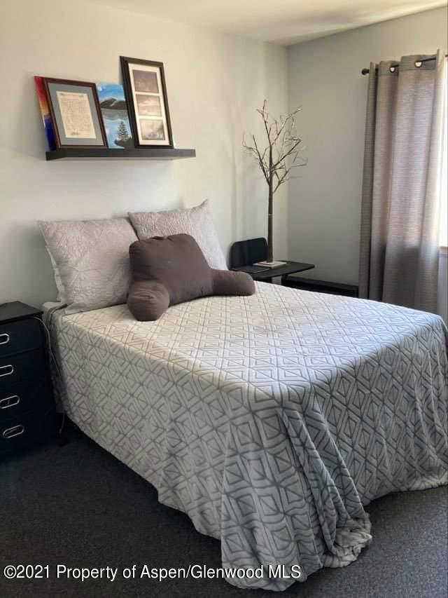 1394 Firethorn Drive Rifle, CO 81650 - Photo 20 of 43 a bedroom with a bed and a painting on the wall