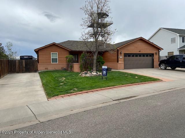 1394 Firethorn Drive Rifle, CO 81650 - Photo 2 of 43 a view of a house with a yard and large tree
