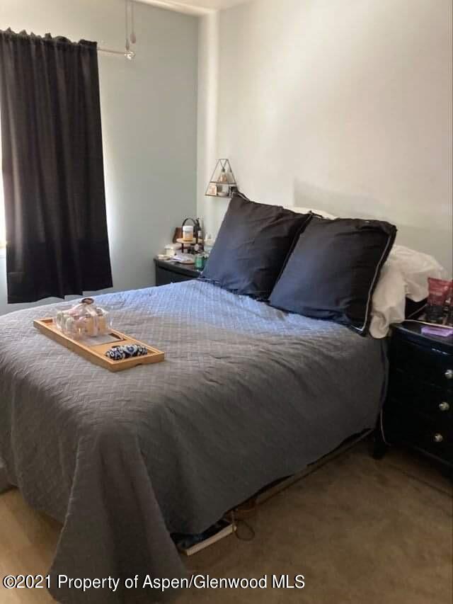 1394 Firethorn Drive Rifle, CO 81650 - Photo 22 of 43 a bedroom with a bed and wooden floor