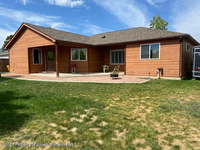 1394 Firethorn Drive Rifle, CO 81650 - Photo 23 of 43 a front view of a house with a yard and garage