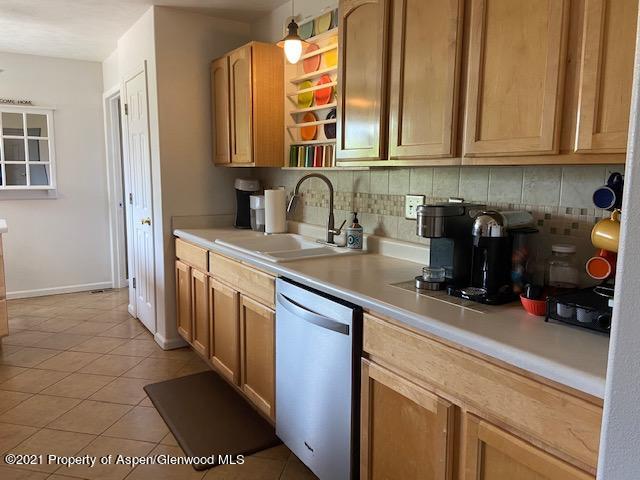 1394 Firethorn Drive Rifle, CO 81650 - Photo 31 of 43 a kitchen with stainless steel appliances granite countertop a sink and cabinets