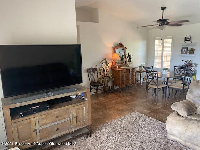 1394 Firethorn Drive Rifle, CO 81650 - Photo 34 of 43 a living room with furniture a flat screen tv and kitchen view