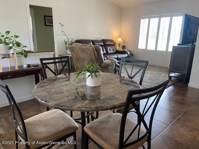 1394 Firethorn Drive Rifle, CO 81650 - Photo 35 of 43 a view of a dining room with furniture and a potted plant