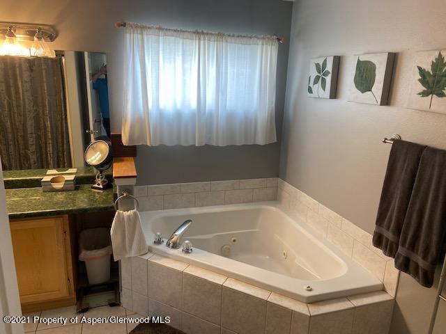 1394 Firethorn Drive Rifle, CO 81650 - Photo 42 of 43 a bathroom with a bathtub sink and mirror