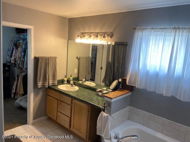 1394 Firethorn Drive Rifle, CO 81650 - Photo 43 of 43 a bathroom with a double vanity sink and a mirror