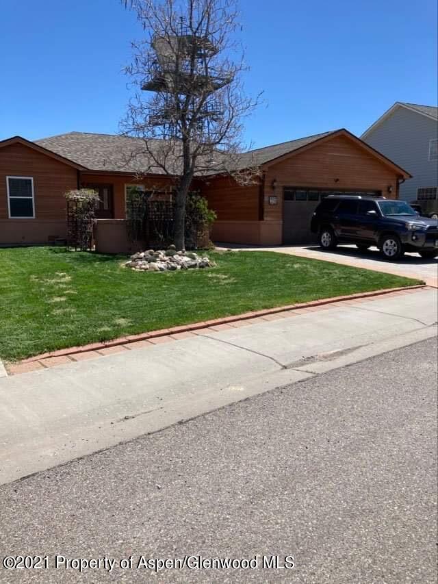 1394 Firethorn Drive Rifle, CO 81650 - Photo 6 of 43 a front view of house with yard and car parked