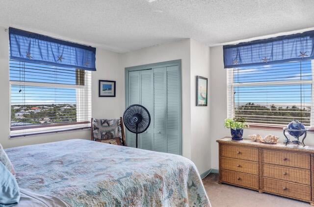 2000 Coco Plum Drive, Unit 603 Marathon, FL 33050 - Photo 11 of 22 a bedroom with a bed and a dresser