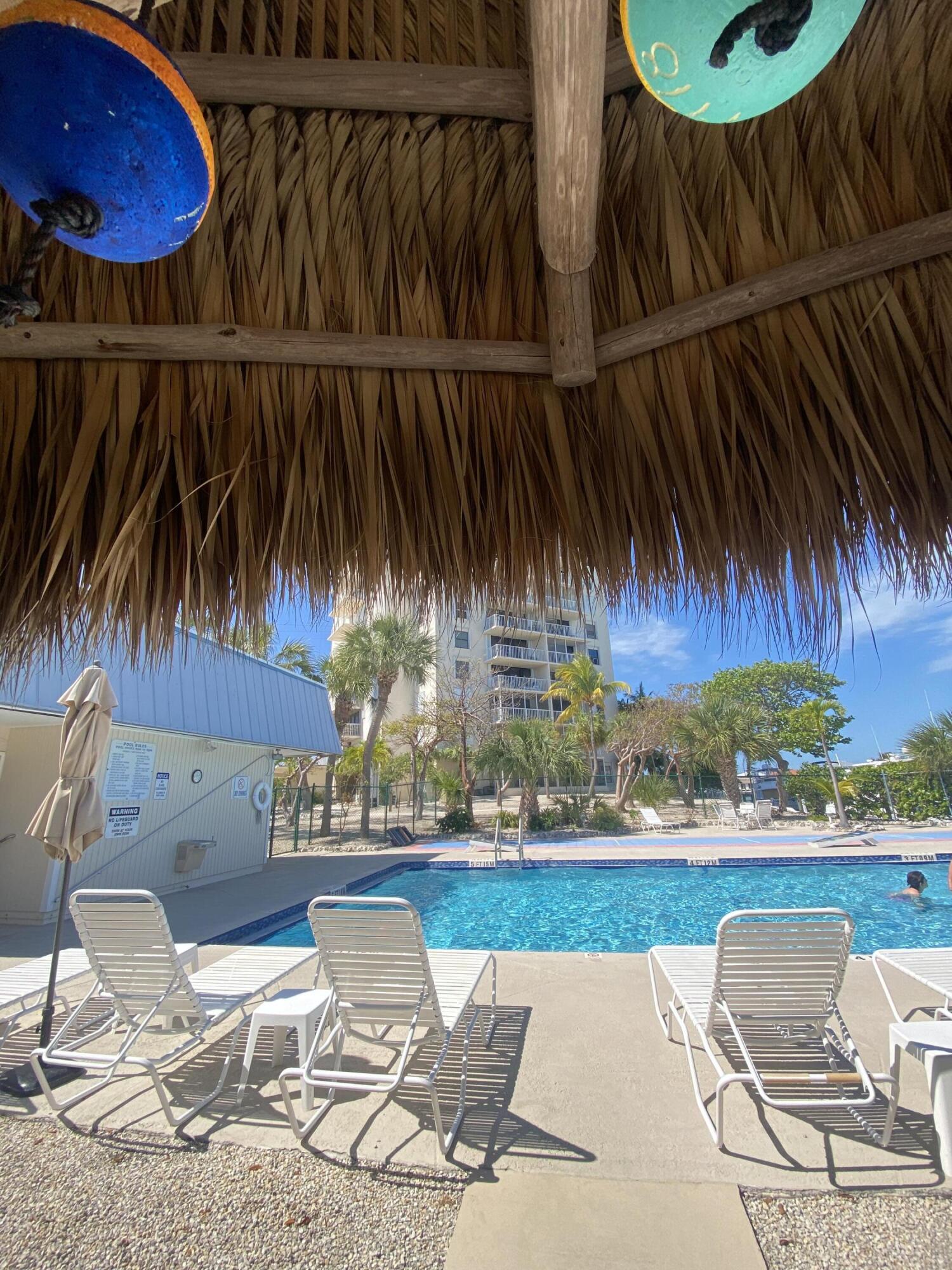 2000 Coco Plum Drive, Unit 603 Marathon, FL 33050 - Photo 15 of 22 a view of outdoor space with swimming pool and patio