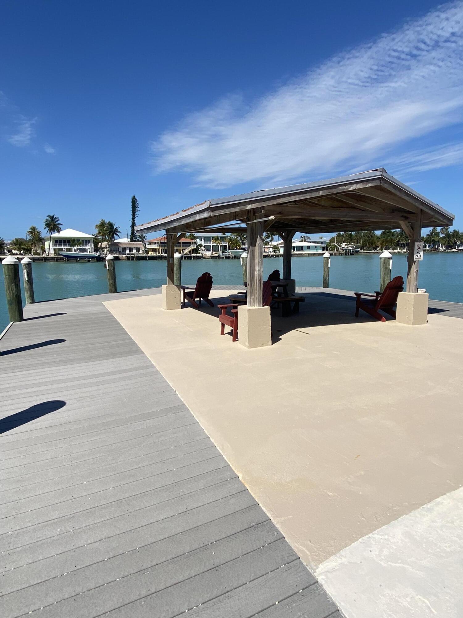 2000 Coco Plum Drive, Unit 603 Marathon, FL 33050 - Photo 20 of 22 a view of outdoor space with swimming pool and furniture