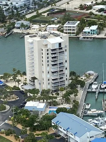 a view of a lake with a building and trees in the background