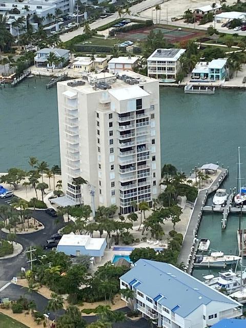 2000 Coco Plum Drive, Unit 603 Marathon, FL 33050 - Photo 22 of 22 a view of a lake with a building and trees in the background
