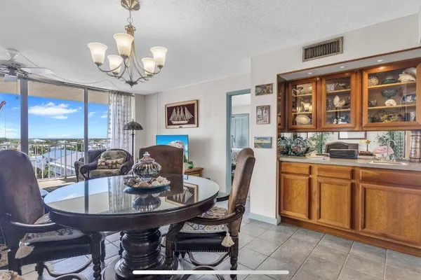 a view of a dining room with furniture a chandelier and wooden floor