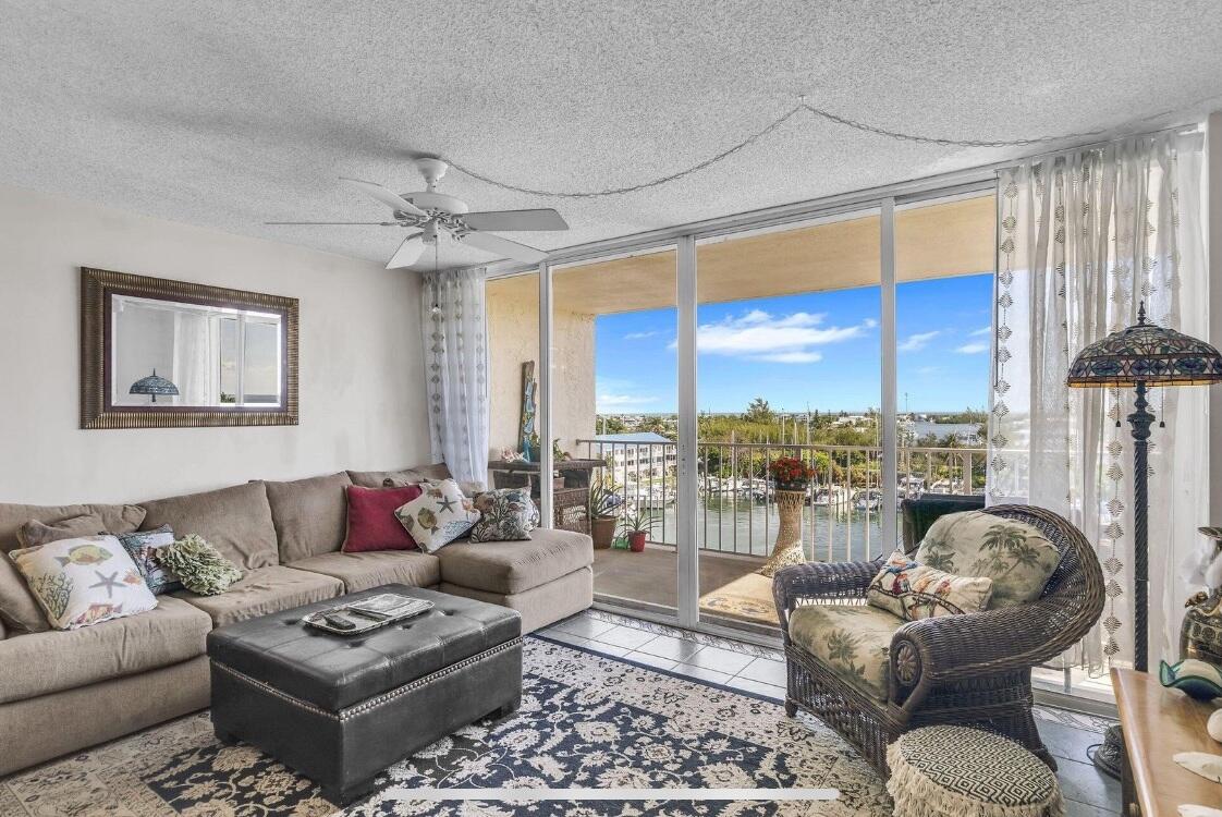 2000 Coco Plum Drive, Unit 603 Marathon, FL 33050 - Photo 7 of 22 a living room with furniture and a large window