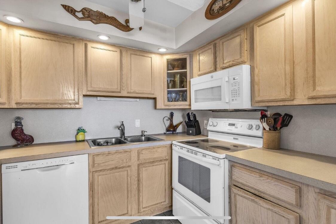 2000 Coco Plum Drive, Unit 603 Marathon, FL 33050 - Photo 9 of 22 a kitchen with stainless steel appliances granite countertop white cabinets sink and dishwasher