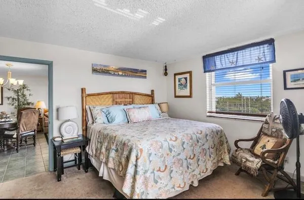 a bedroom with a bed a table and chair