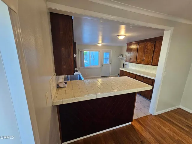 a large kitchen with a stove a refrigerator and a sink