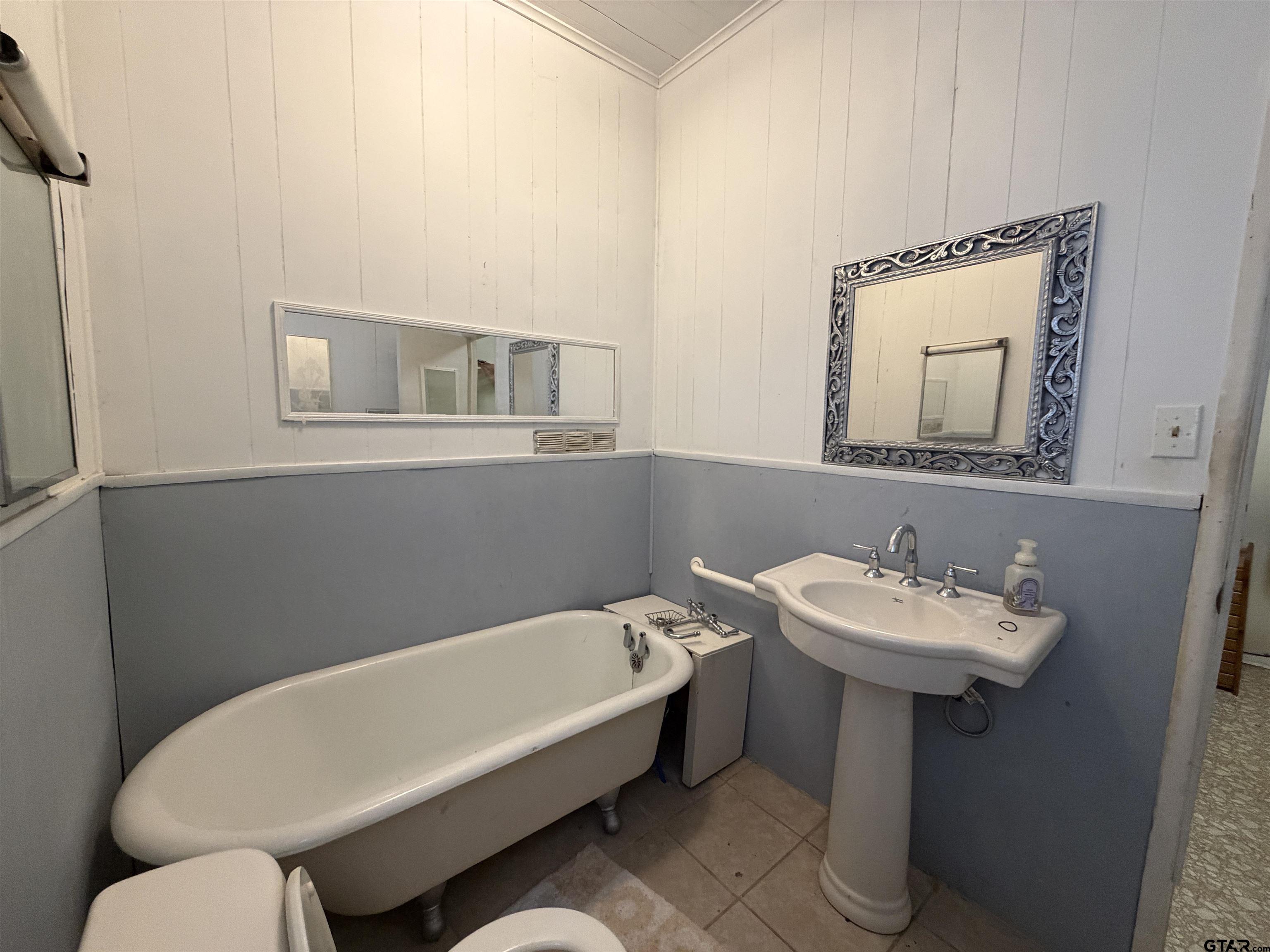 609 Walnut Mineola, TX 75773 - Photo 11 of 23 a bathroom with a sink mirror and toilet