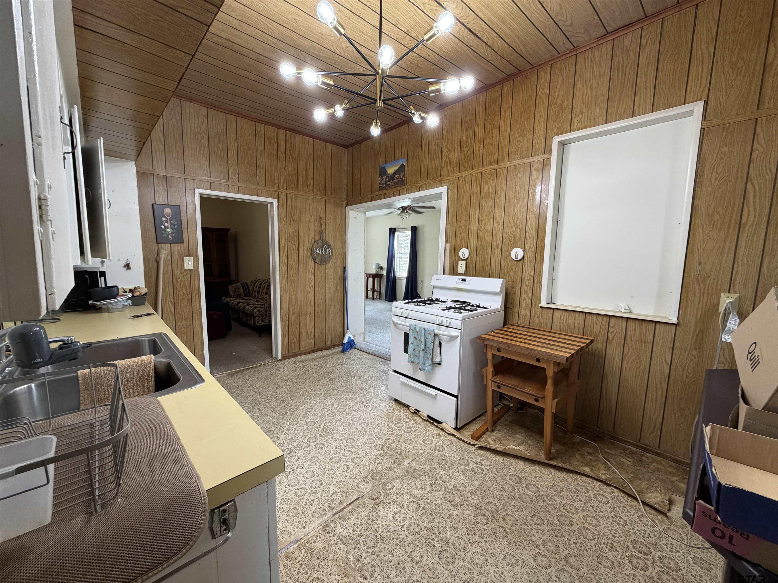 609 Walnut Mineola, TX 75773 - Photo 12 of 23 a living room with furniture a flat screen tv and kitchen view