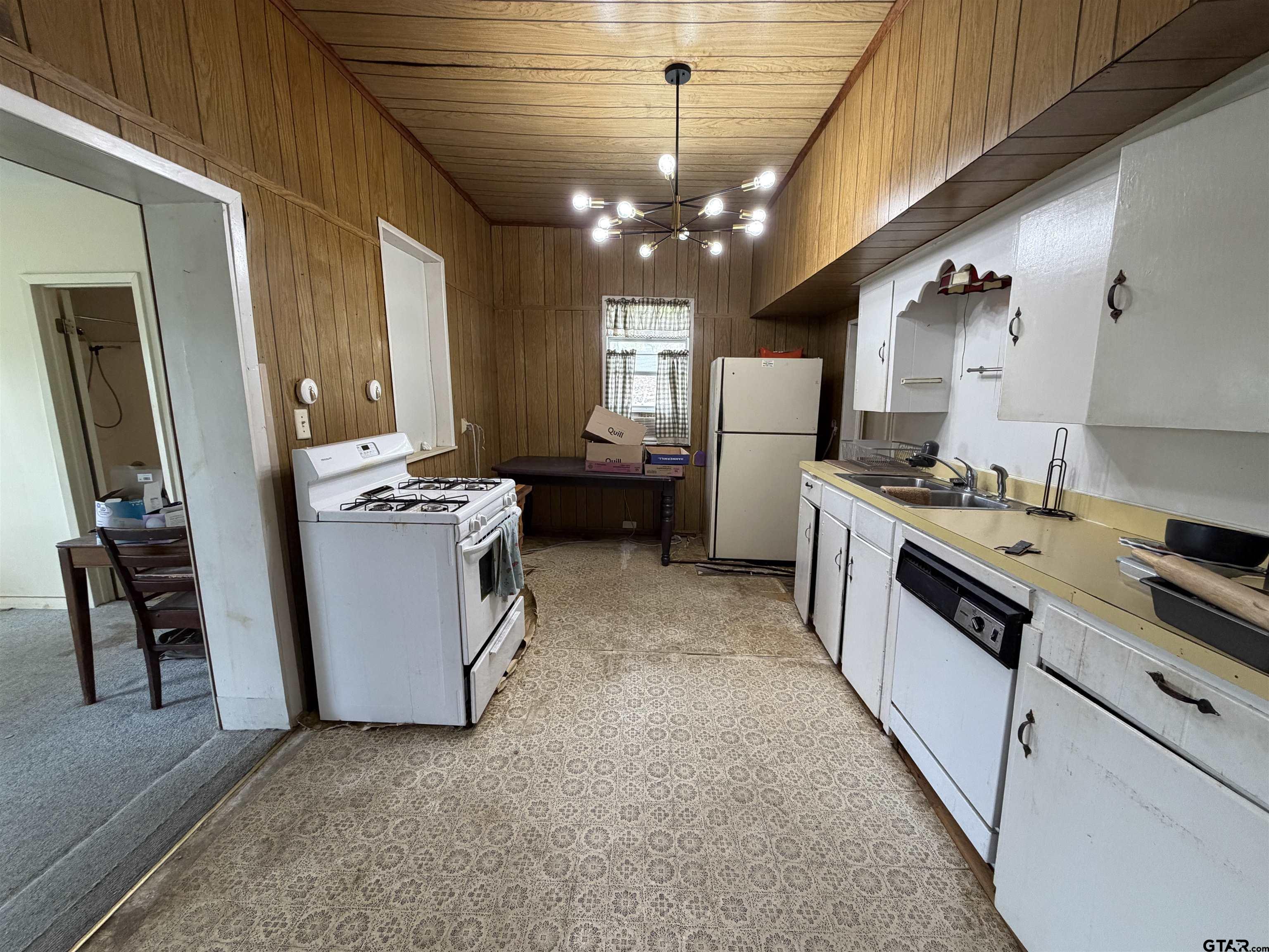 609 Walnut Mineola, TX 75773 - Photo 14 of 23 a kitchen with stove a refrigerator and chairs