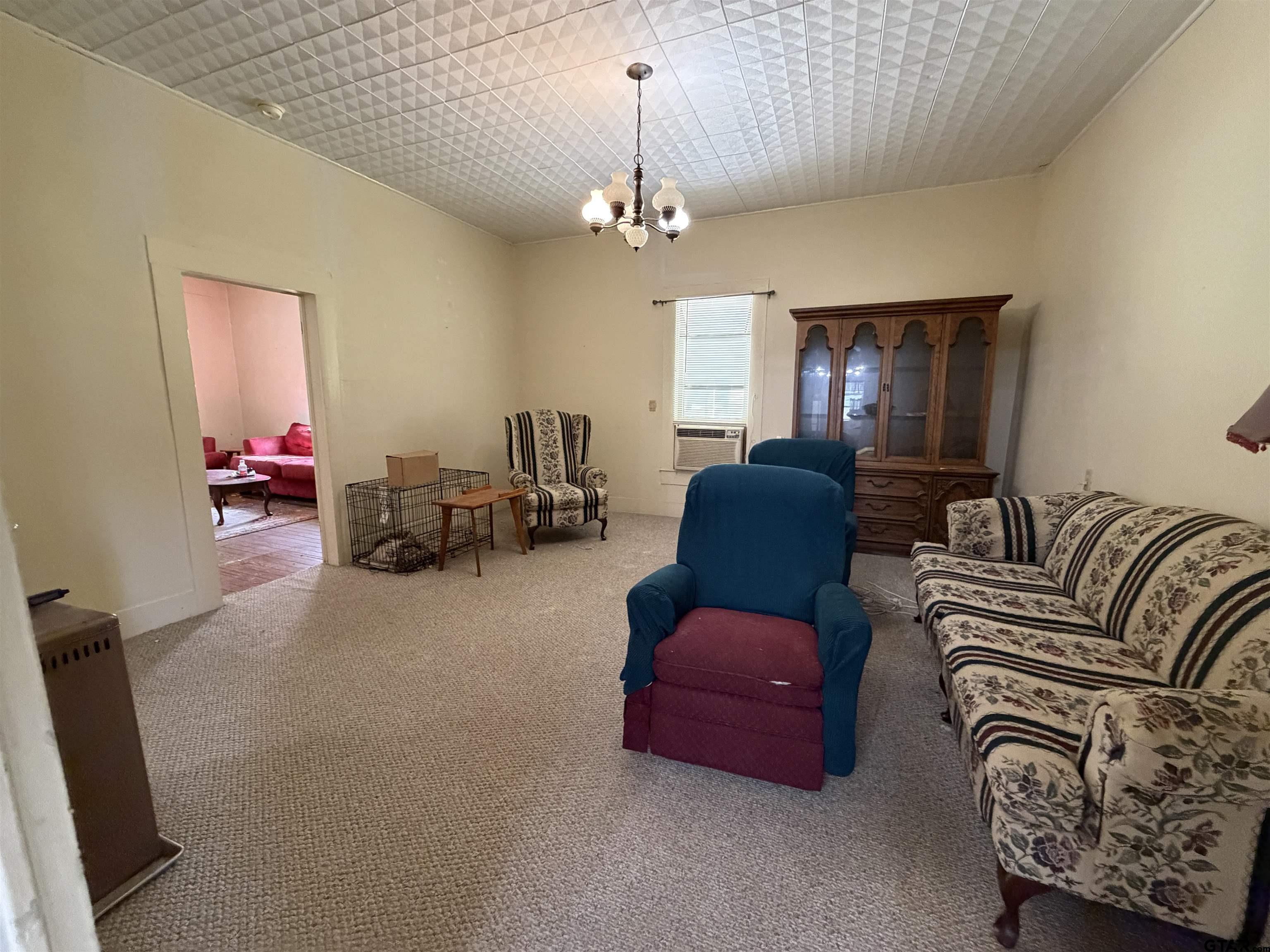 609 Walnut Mineola, TX 75773 - Photo 15 of 23 a living room with furniture a chandelier and a window