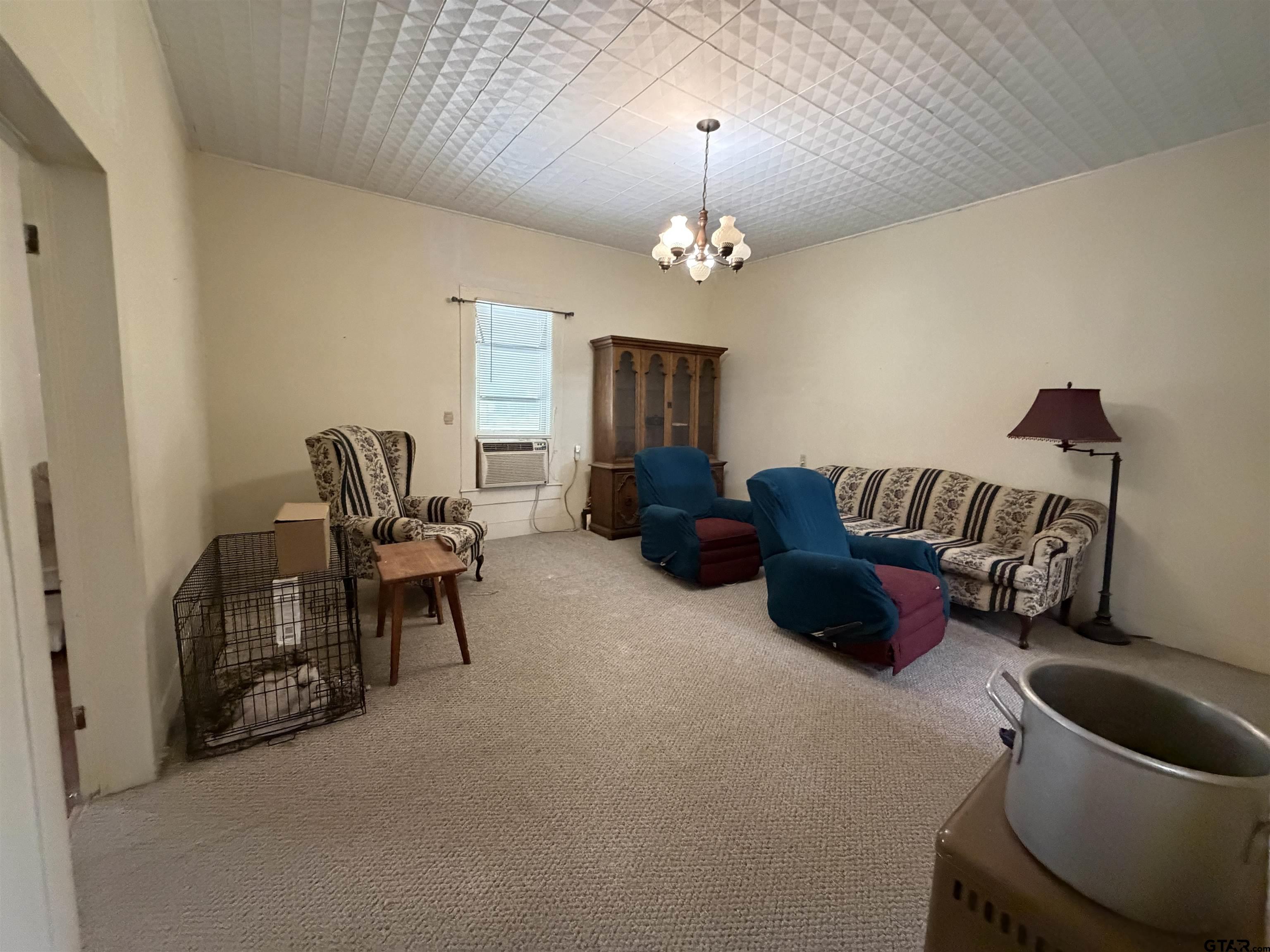 609 Walnut Mineola, TX 75773 - Photo 16 of 23 a living room with furniture and a chandelier