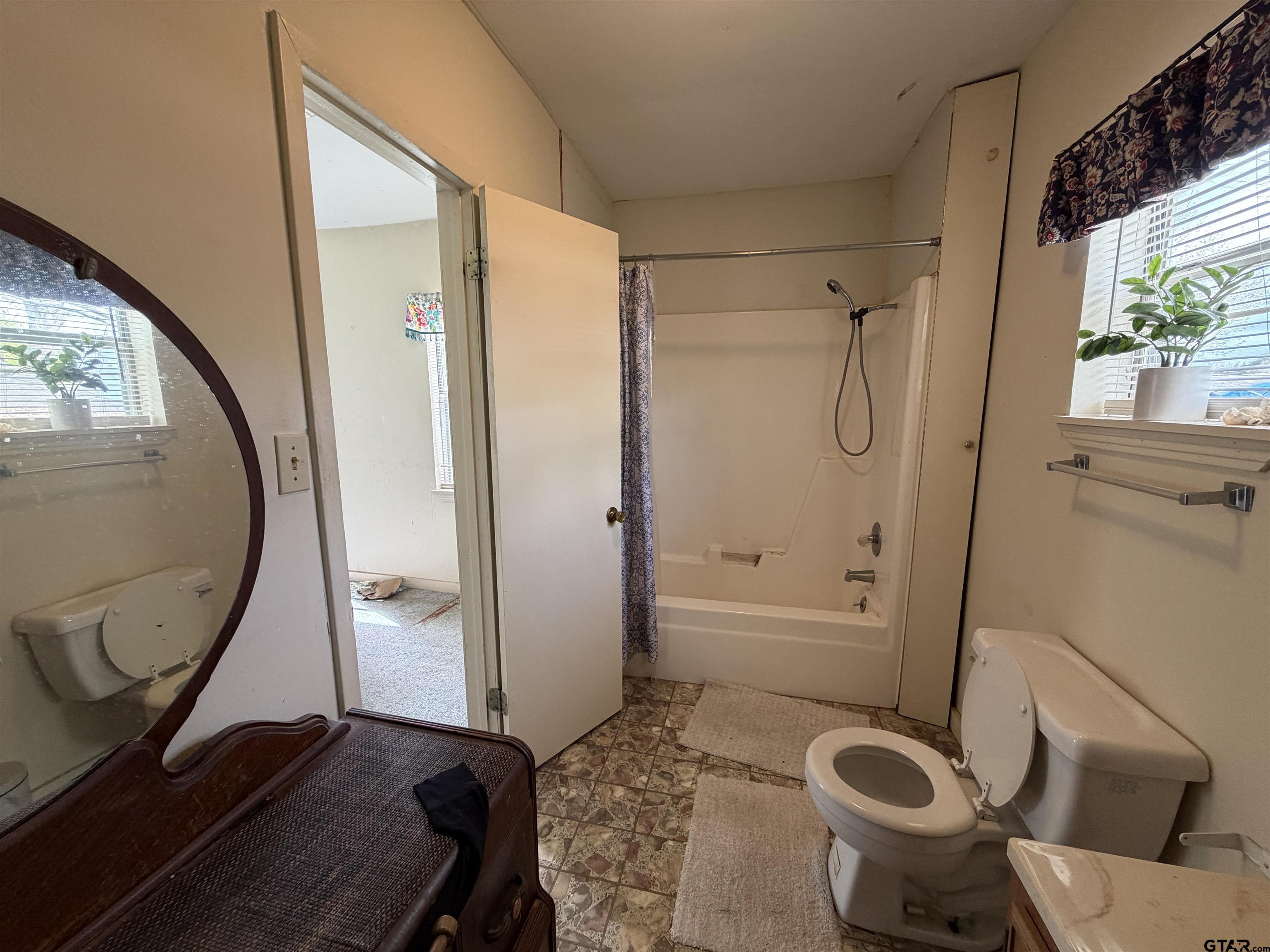 609 Walnut Mineola, TX 75773 - Photo 19 of 23 a bathroom with a sink toilet and shower