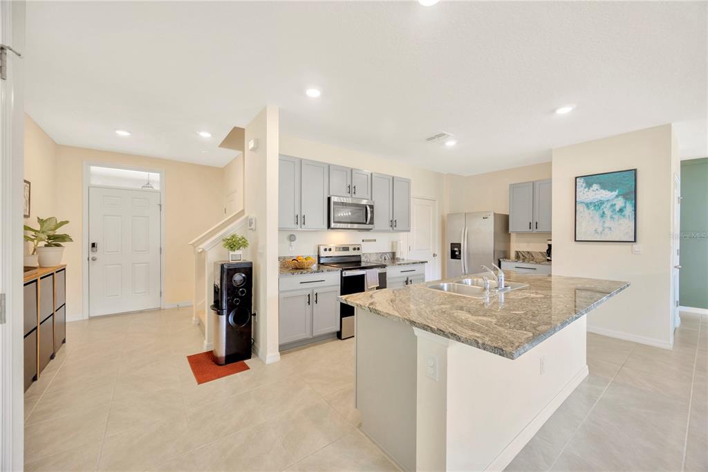 5674 Banbury Ridge Run Wesley Chapel, FL 33545 - Photo 11 of 40 a kitchen with refrigerator and window