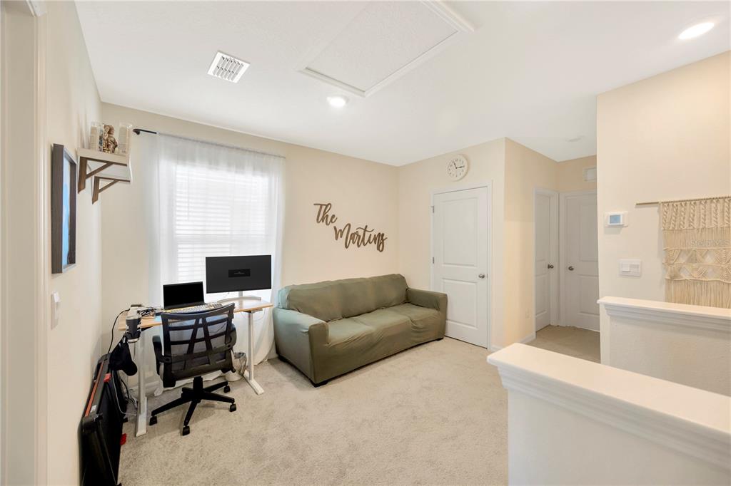 5674 Banbury Ridge Run Wesley Chapel, FL 33545 - Photo 15 of 40 a living room with furniture and a fireplace