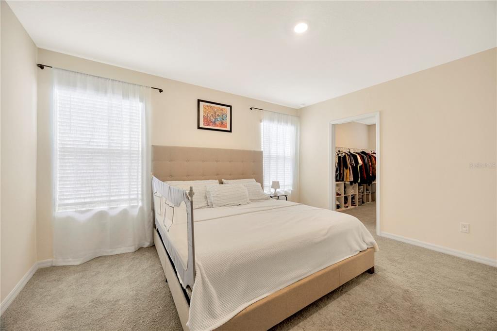 5674 Banbury Ridge Run Wesley Chapel, FL 33545 - Photo 23 of 40 a bedroom with a bed and a window