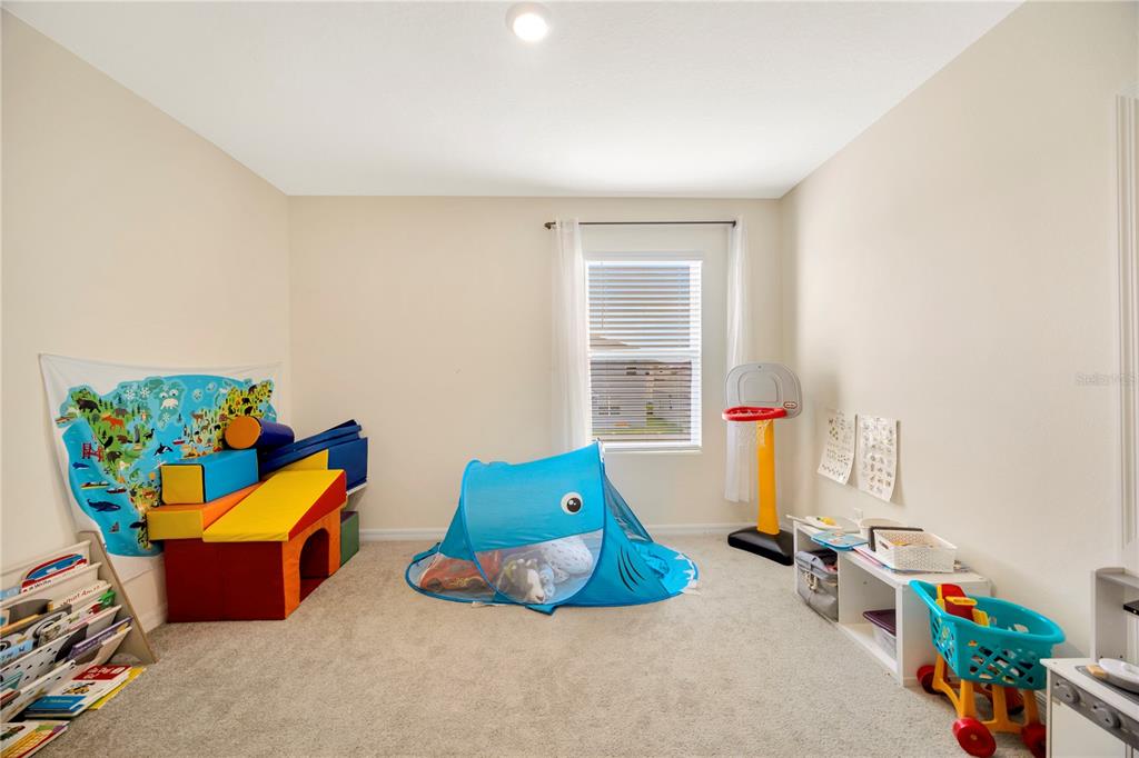 5674 Banbury Ridge Run Wesley Chapel, FL 33545 - Photo 26 of 40 a room with toys and a wooden floor