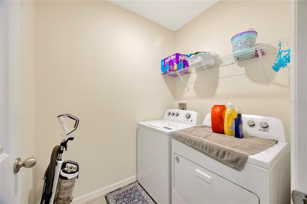 5674 Banbury Ridge Run Wesley Chapel, FL 33545 - Photo 28 of 40 a utility room with a window dryer and washer