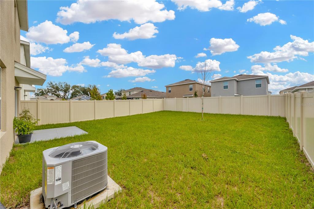 5674 Banbury Ridge Run Wesley Chapel, FL 33545 - Photo 29 of 40 a view of a backyard with a garden
