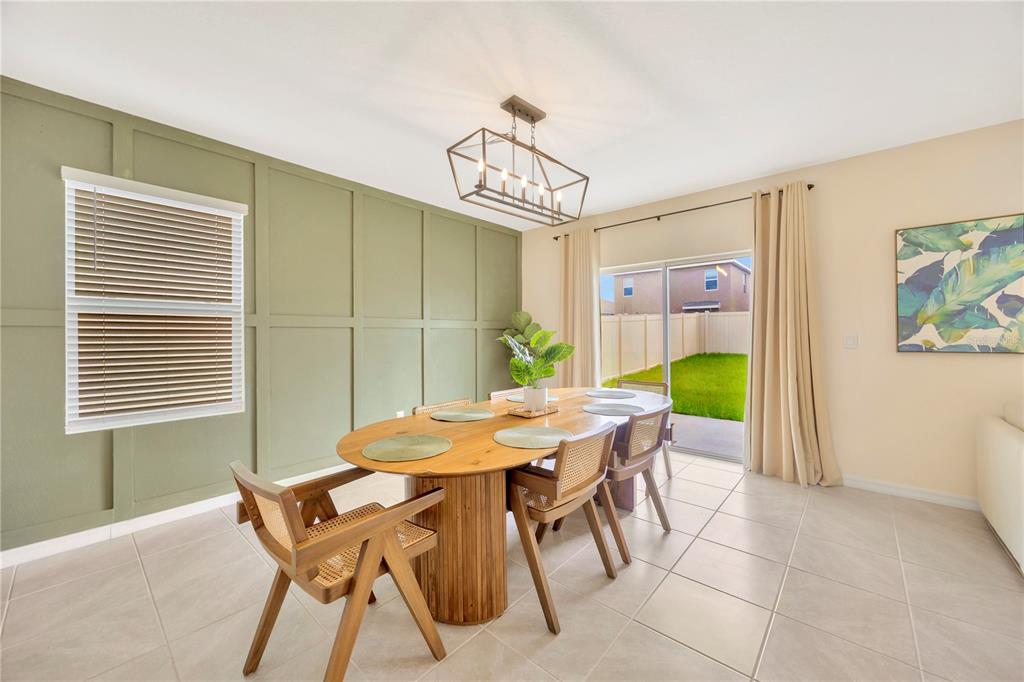 5674 Banbury Ridge Run Wesley Chapel, FL 33545 - Photo 5 of 40 a view of a dining room with furniture and a table and chair