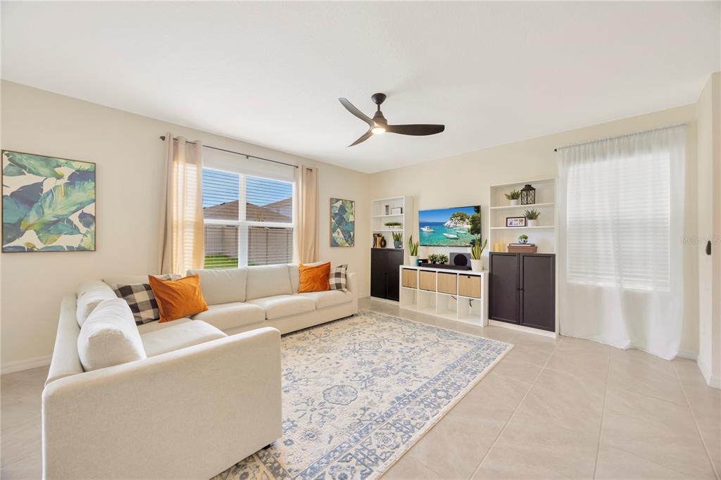 5674 Banbury Ridge Run Wesley Chapel, FL 33545 - Photo 8 of 40 a living room with furniture and a large window