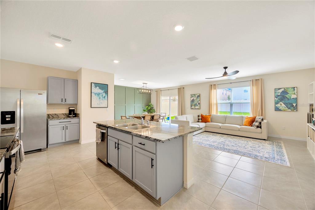 5674 Banbury Ridge Run Wesley Chapel, FL 33545 - Photo 10 of 40 a kitchen with stainless steel appliances granite countertop a sink and cabinets